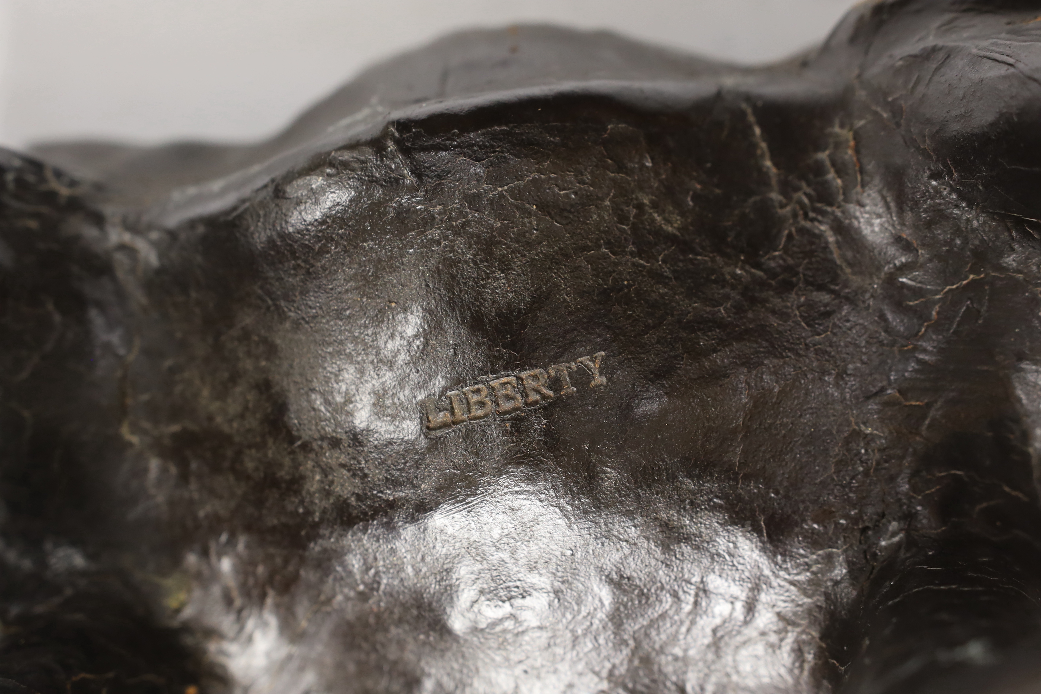A leather rhinoceros figure with glass eyes, stamped Liberty to the underside, 54cm wide